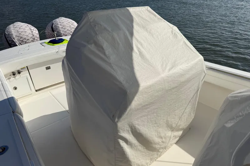  Yacht Photos Pics 2020 Regulator 31 boat with covered console, docked on calm water.