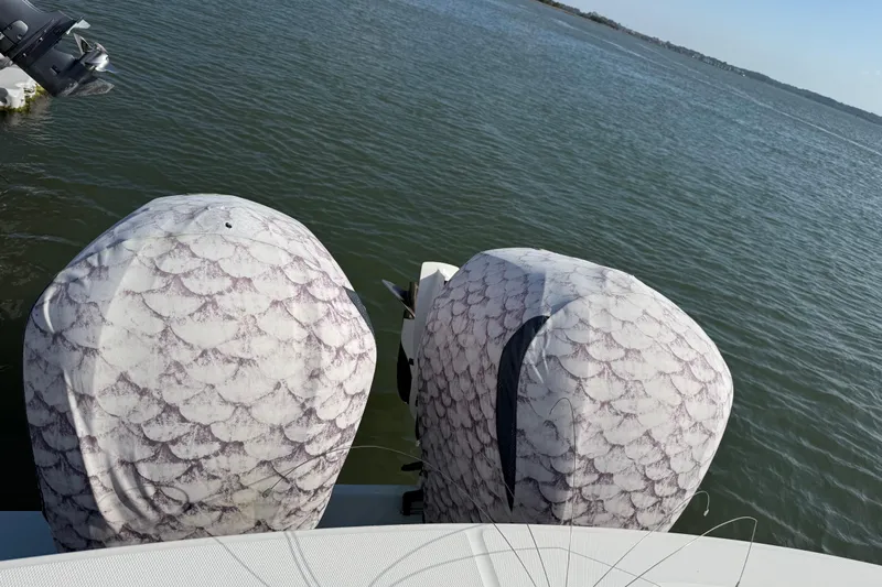  Yacht Photos Pics 2020 Regulator 31 boat with patterned engine covers on calm water.