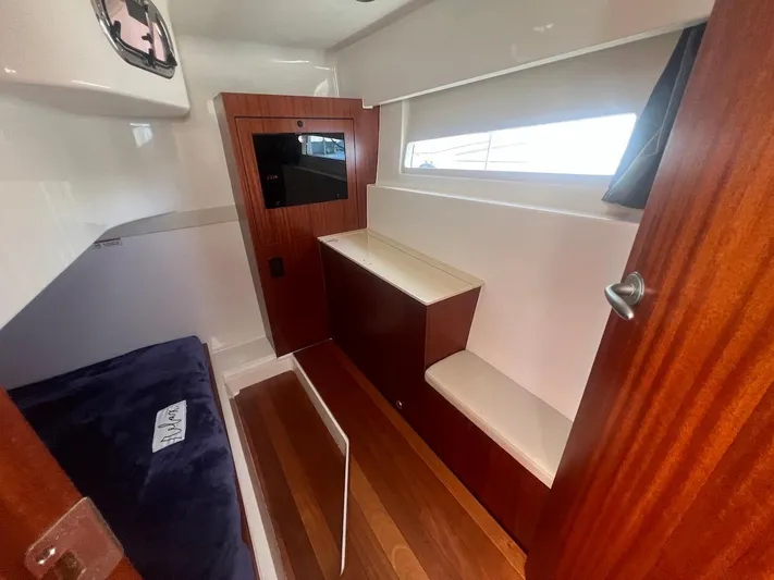  Yacht Photos Pics Interior cabin of 2015 Pursuit SC 365i Sport Coupe with wood accents and seating.