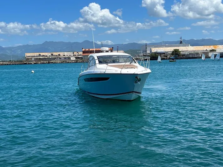  Yacht Photos Pics 2015 Pursuit SC 365i Sport Coupe cruising in clear blue waters.