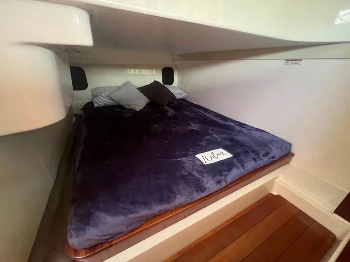  Yacht Photos Pics Cozy cabin bed in 2015 Pursuit SC 365i Sport Coupe with plush bedding.