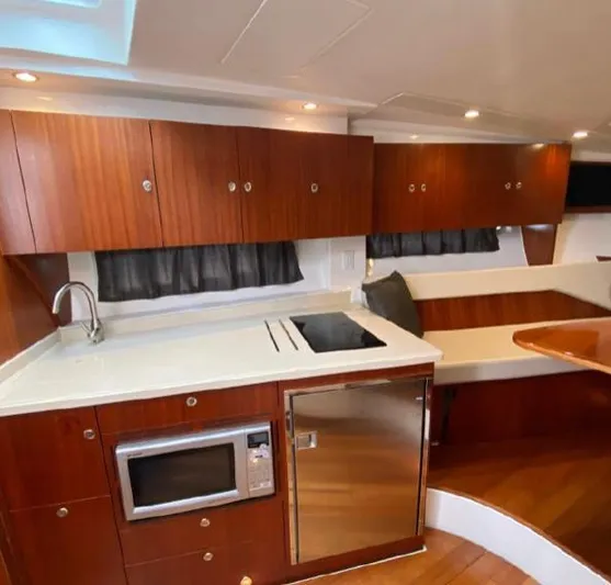  Yacht Photos Pics Luxurious 2015 Pursuit SC 365i Sport Coupe interior with modern kitchen amenities.