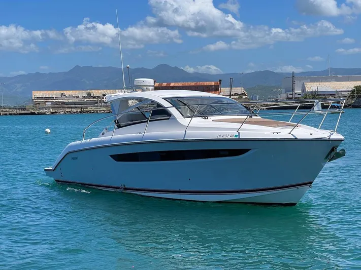  Yacht Photos Pics 2015 Pursuit SC 365i Sport Coupe on clear blue water, with industrial backdrop.