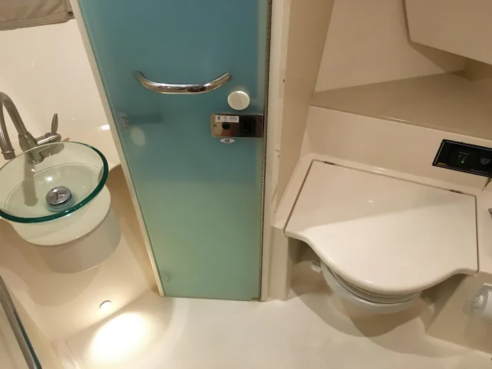  Yacht Photos Pics 2015 Pursuit SC 365i Sport Coupe bathroom with glass sink and modern fixtures.