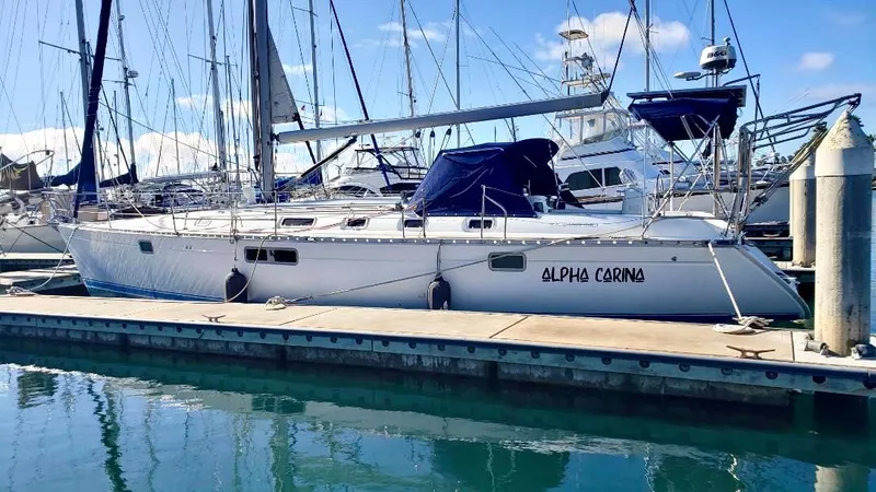 Alpha Carina Yacht Photos Pics Sailboat Beneteau Oceanis 440, 1993 model, docked at marina under clear blue sky.