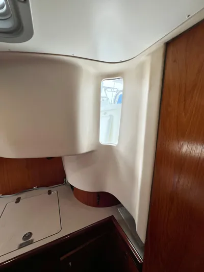 Alpha Carina Yacht Photos Pics Interior view of 1993 Beneteau Oceanis 440 sailboat, featuring wood paneling and compact design.