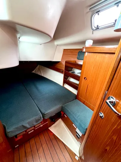 Alpha Carina Yacht Photos Pics Cozy cabin interior of 1993 Beneteau Oceanis 440 sailboat with wooden furnishings.
