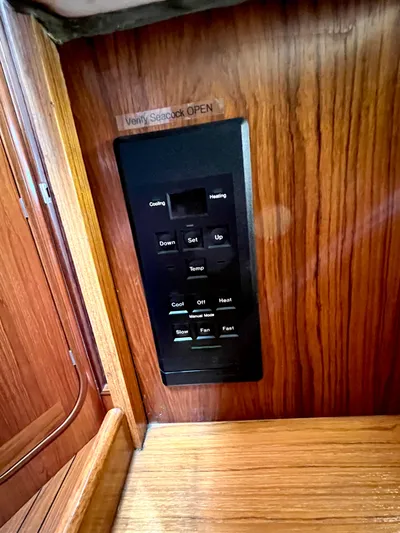 Alpha Carina Yacht Photos Pics Control panel on a 1993 Beneteau Oceanis 440 yacht, set in wooden interior.