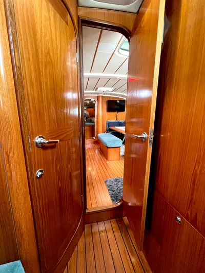 Alpha Carina Yacht Photos Pics Interior view of 1993 Beneteau Oceanis 440 sailboat with wooden finish and cozy seating area.