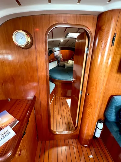 Alpha Carina Yacht Photos Pics Interior of 1993 Beneteau Oceanis 440 sailboat, featuring polished wood and cozy cabin space.