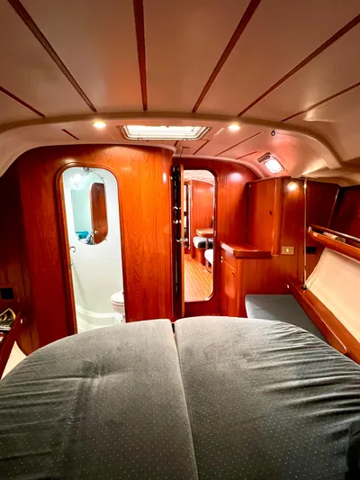 Alpha Carina Yacht Photos Pics Interior of 1993 Beneteau Oceanis 440 sailboat, featuring cozy wood paneling and modern amenities.