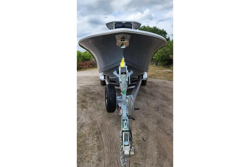  Yacht Photos Pics 2023 Tidewater 292 CC Adventure boat on trailer, front view, outdoors.