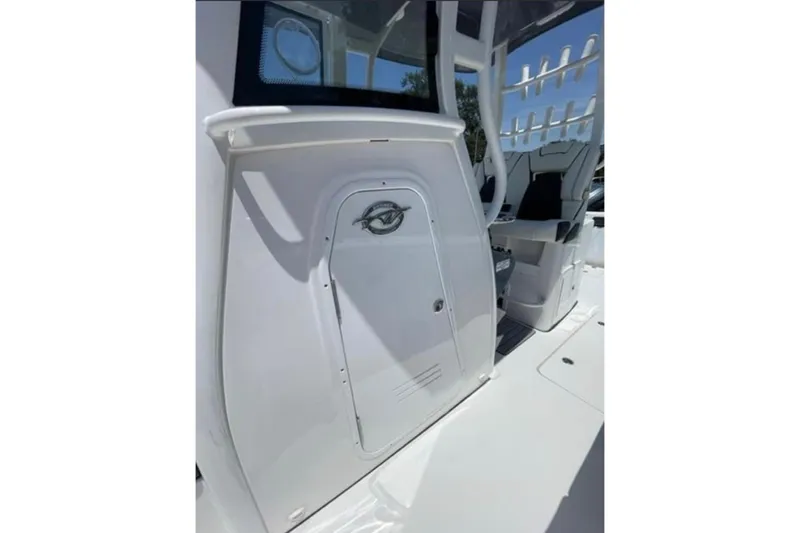  Yacht Photos Pics 2023 Tidewater 292 CC Adventure boat interior with seating and storage compartment.