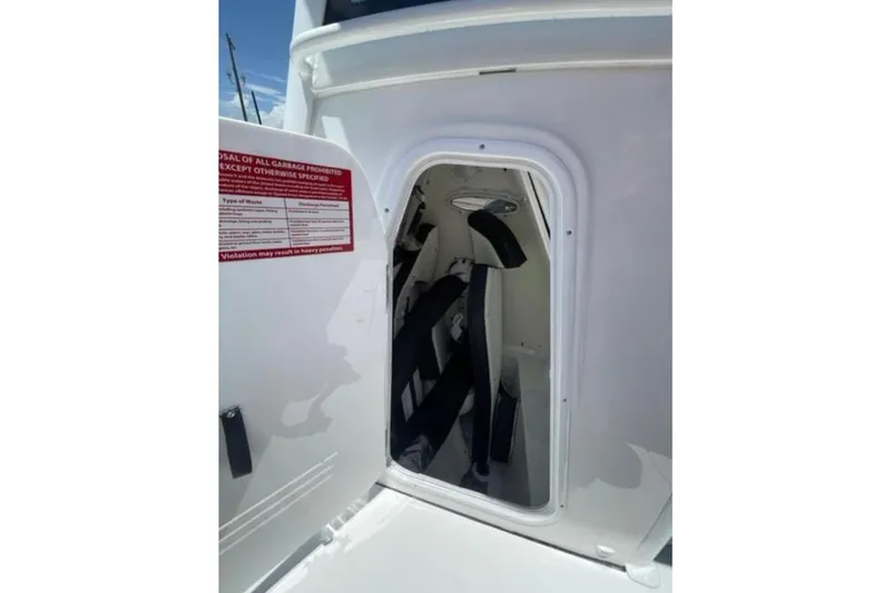  Yacht Photos Pics 2023 Tidewater 292 CC Adventure boat storage compartment with safety equipment.
