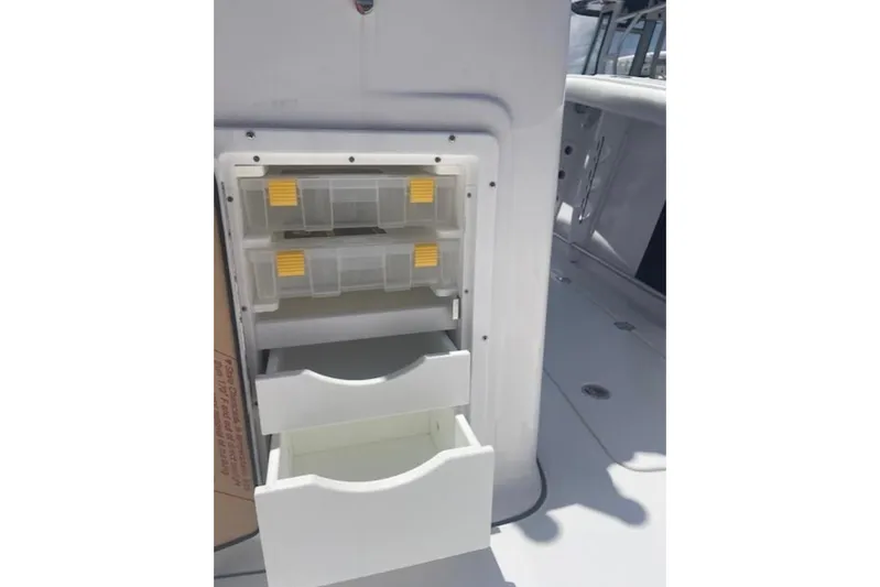  Yacht Photos Pics Storage compartments on 2023 Tidewater 292 CC Adventure boat, featuring organized tackle boxes.