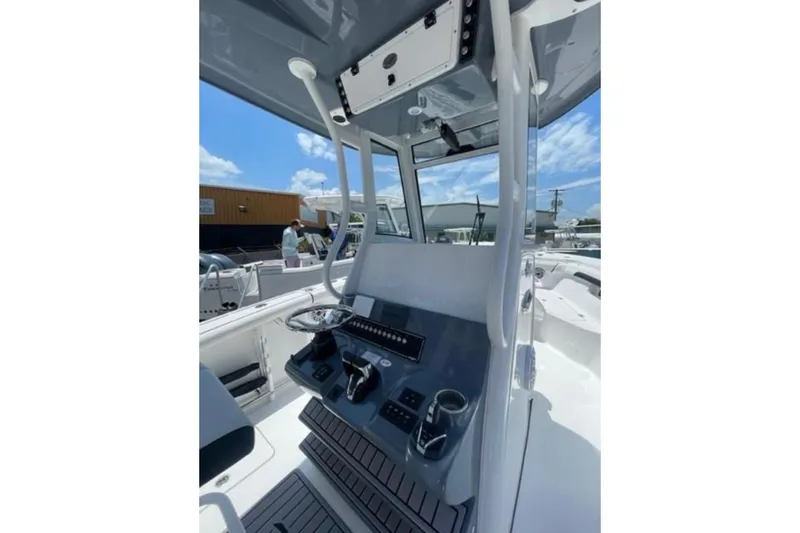  Yacht Photos Pics 2023 Tidewater 292 CC Adventure boat console with modern controls and steering wheel.