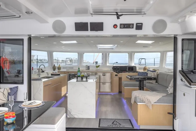  Yacht Photos Pics Luxurious interior of 2027 Balance 580 yacht with modern kitchen and seating area.