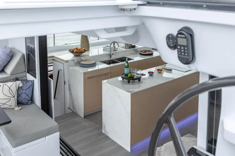  Yacht Photos Pics Luxurious interior of 2027 Balance 580 yacht with modern kitchen and seating area.