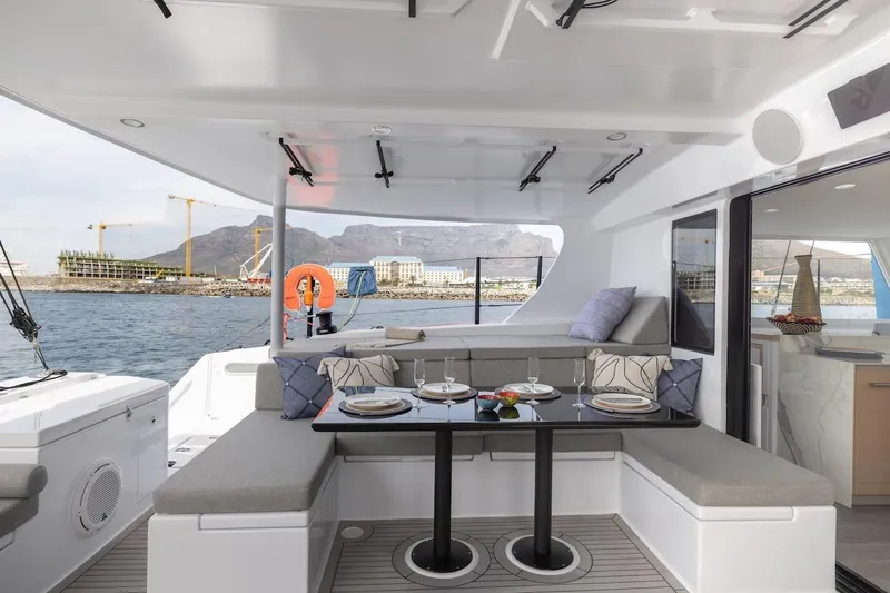  Yacht Photos Pics Luxurious 2027 Balance 580 yacht interior with elegant dining setup and scenic ocean view.