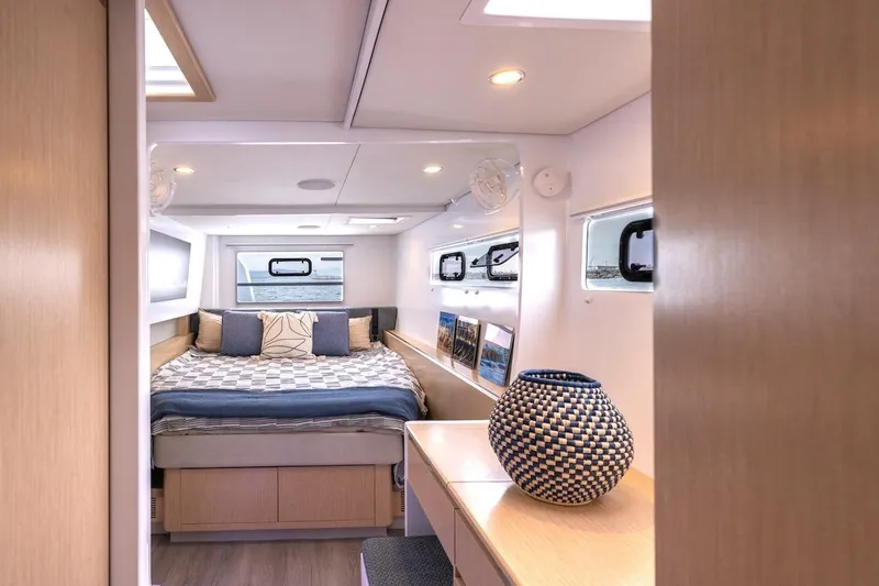  Yacht Photos Pics Luxurious cabin interior of 2027 Balance 580 yacht with cozy bed and stylish decor.