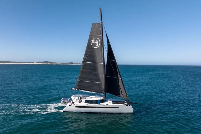  Yacht Photos Pics Sailing catamaran Balance 580, 2027 model, cruising on open sea under clear blue sky.