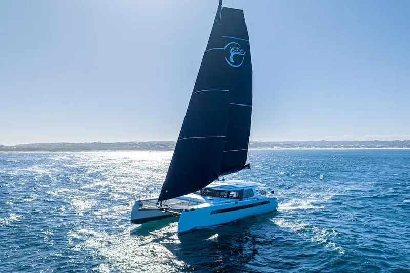  Yacht Photos Pics Sailing catamaran Balance 580, 2027 model, gliding on open sea under clear blue sky.
