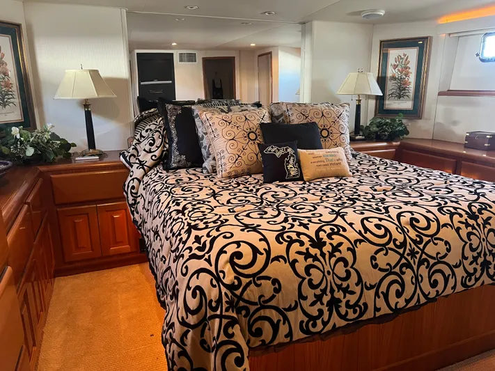  Yacht Photos Pics Luxurious bedroom interior of a 1995 Viking Sports Yacht with elegant bedding and decor.