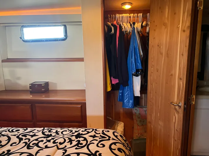  Yacht Photos Pics Cozy cabin interior of 1995 Viking Sports Yacht with closet and window.