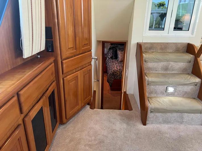  Yacht Photos Pics Interior of 1995 Viking Sports Yacht with wooden cabinetry and carpeted stairs.