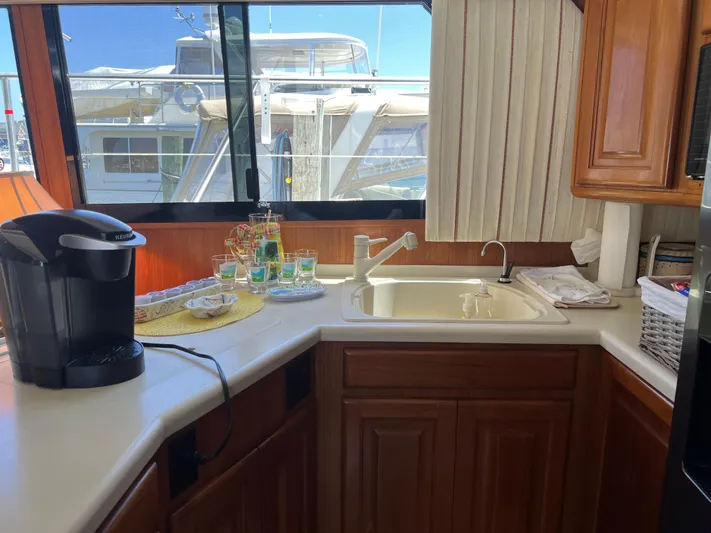  Yacht Photos Pics Interior of 1995 Viking Sports Yacht kitchen with sink, coffee maker, and window view.