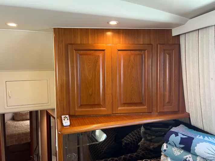  Yacht Photos Pics Interior of 1995 Viking Sports Yacht with wooden cabinetry and cozy bedding.