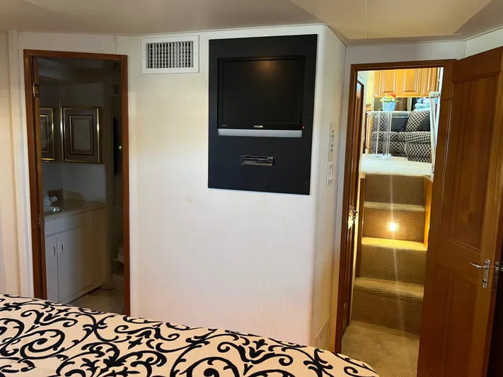  Yacht Photos Pics Interior of a 1995 Viking Sports Yacht with TV, stairs, and bathroom.