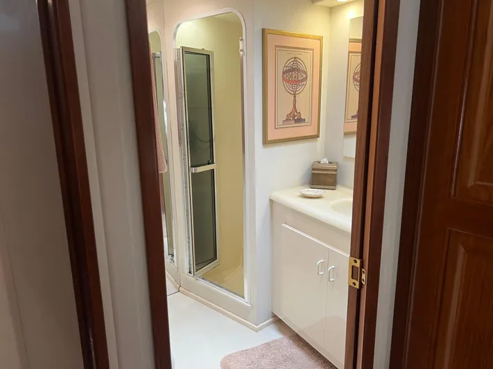  Yacht Photos Pics Bathroom interior of a 1995 Viking Sports Yacht with shower and framed artwork.
