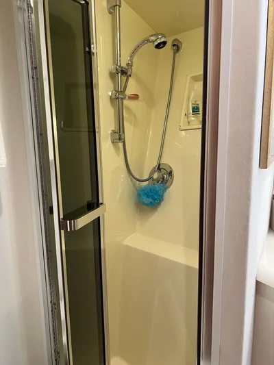  Yacht Photos Pics Shower area inside a 1995 Viking Sports Yacht, featuring a handheld showerhead and glass door.