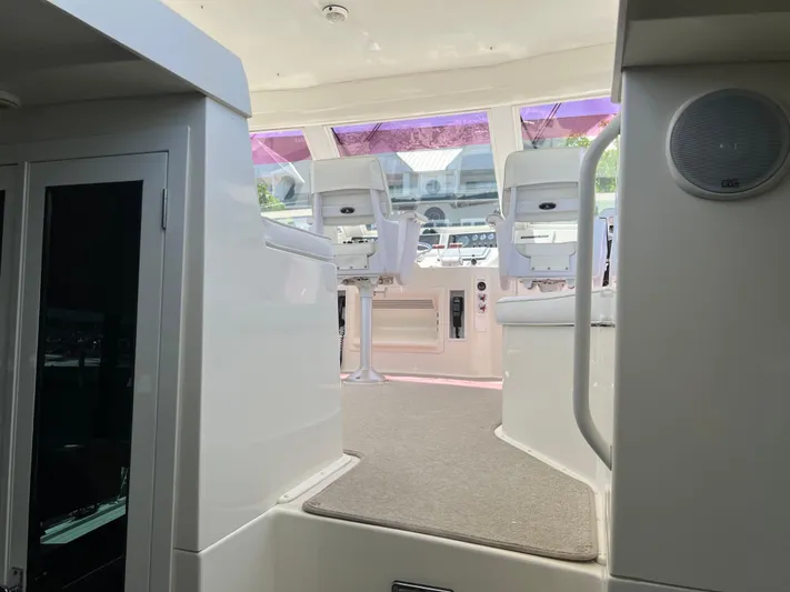  Yacht Photos Pics Interior view of a 1995 Viking Sports Yacht cockpit with white seating and control panel.