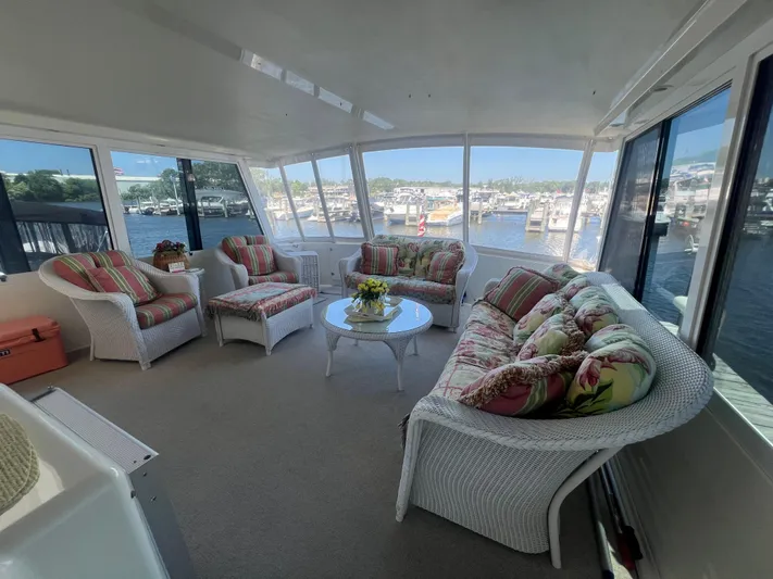  Yacht Photos Pics Luxurious 1995 Viking Sports Yacht interior with wicker furniture and marina view.