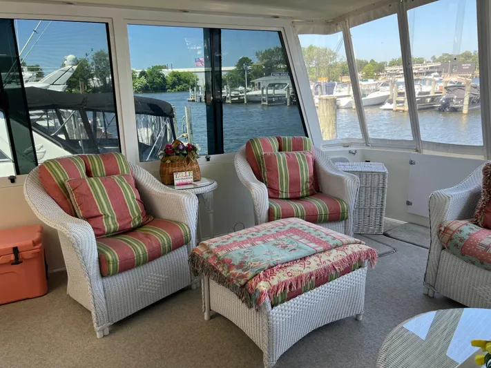  Yacht Photos Pics Cozy interior of a 1995 Viking Sports Yacht with wicker chairs and marina view.