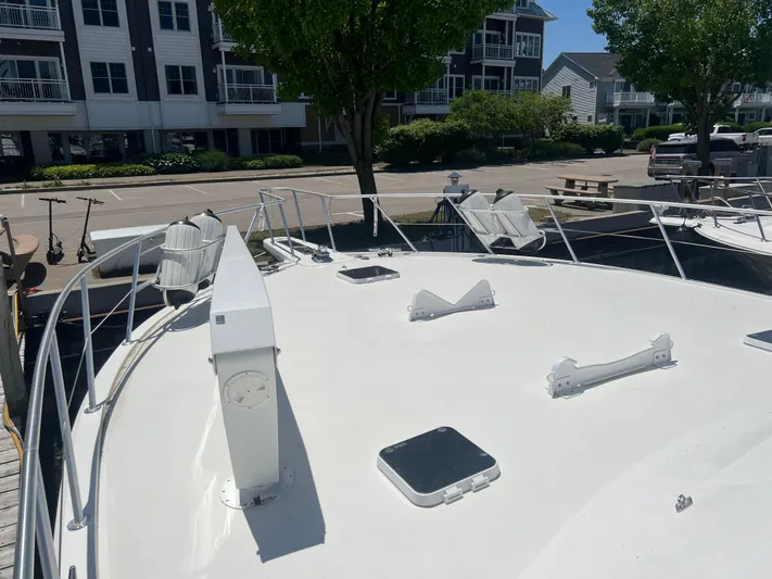  Yacht Photos Pics 1995 Viking Sports Yacht docked near residential buildings, showcasing its spacious deck.