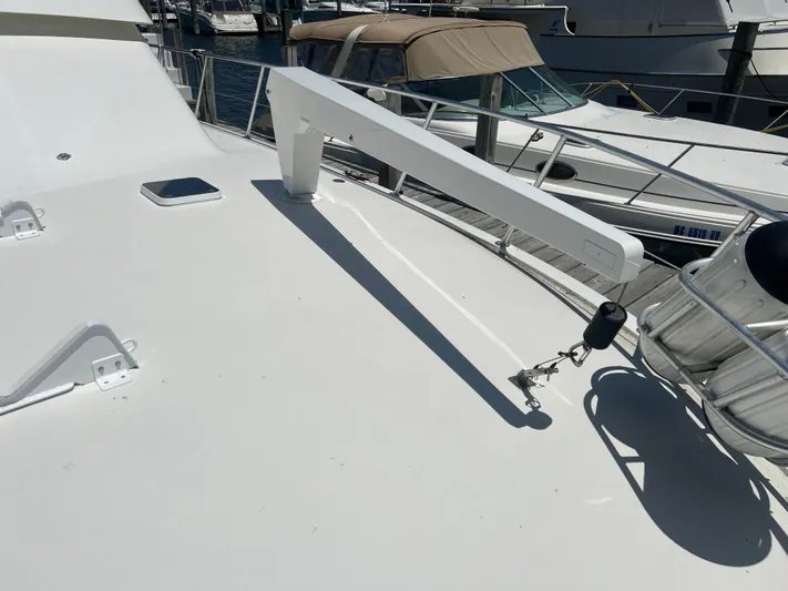  Yacht Photos Pics 1995 Viking Sports Yacht deck with davit and lifebuoy, docked at marina.