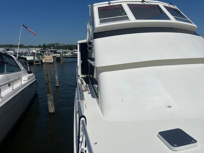  Yacht Photos Pics 1995 Viking Sports Yacht docked at marina under clear blue sky.