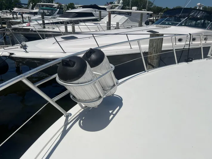  Yacht Photos Pics 1995 Viking Sports Yacht docked, featuring sleek design and fender holders on deck.