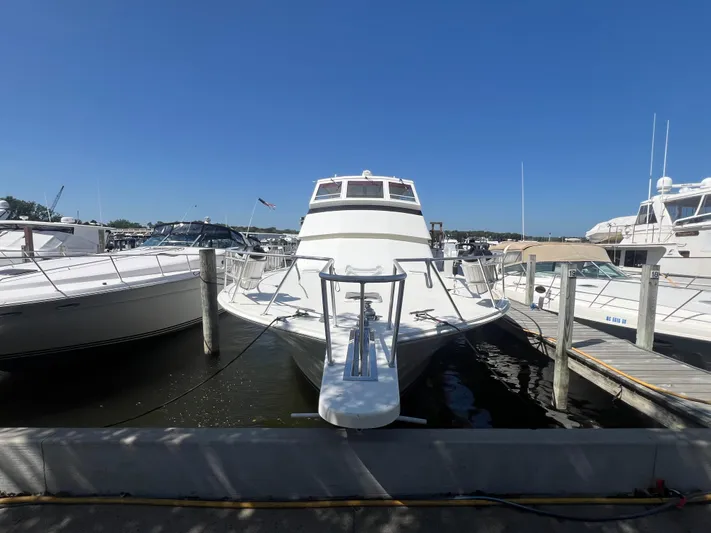  Yacht Photos Pics 1995 Viking Sports Yacht docked at marina under clear blue sky.