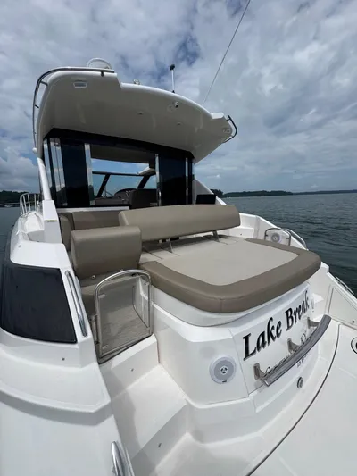 Lake Break Yacht Photos Pics 2016 Regal 42 Sport Coupe yacht on a lake under cloudy skies.