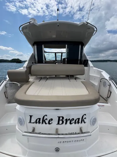 Lake Break Yacht Photos Pics 2016 Regal 42 Sport Coupe boat named "Lake Break" on a lake under cloudy sky.