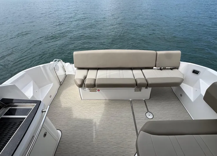 Lake Break Yacht Photos Pics 2016 Regal 42 Sport Coupe boat interior with beige seating and ocean view.