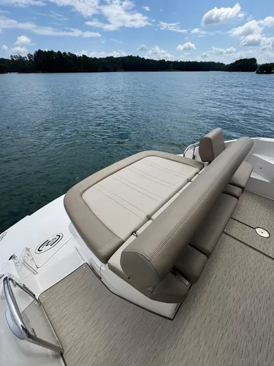 Lake Break Yacht Photos Pics 2016 Regal 42 Sport Coupe boat with cushioned seating on a serene lake.