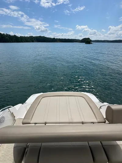 Lake Break Yacht Photos Pics 2016 Regal 42 Sport Coupe boat on a serene lake under a blue sky.