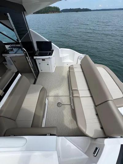 Lake Break Yacht Photos Pics 2016 Regal 42 Sport Coupe boat interior with beige seating and lake view.