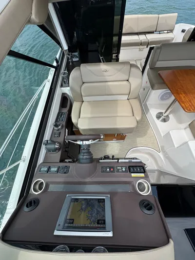 Lake Break Yacht Photos Pics Interior of 2016 Regal 42 Sport Coupe, featuring helm controls and seating.