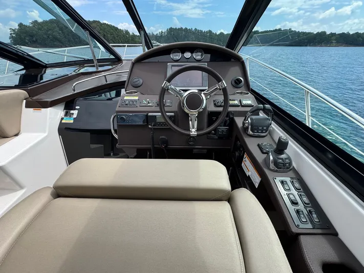 Lake Break Yacht Photos Pics Helm of 2016 Regal 42 Sport Coupe with modern controls and scenic lake view.